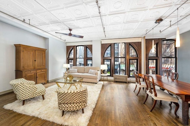 living room featuring wood-type flooring and ceiling fan