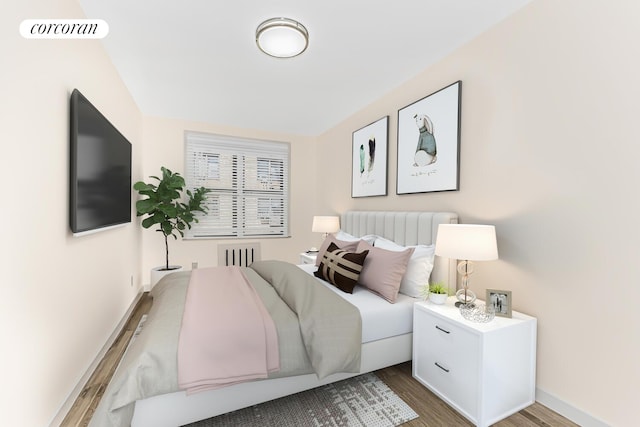 bedroom featuring radiator and hardwood / wood-style floors