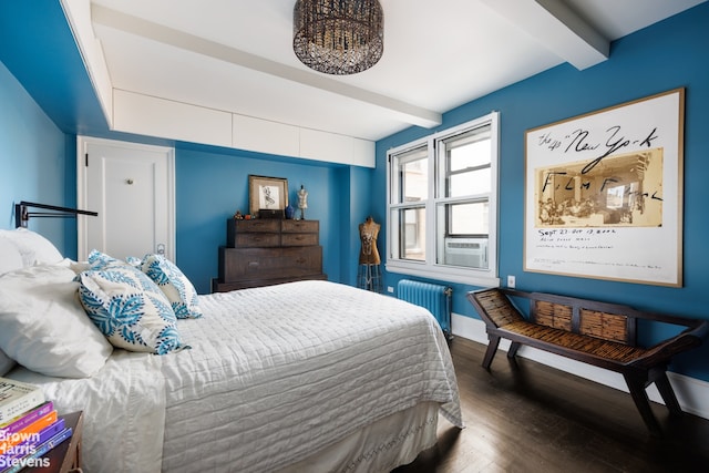 bedroom featuring dark hardwood / wood-style floors, beamed ceiling, and radiator heating unit