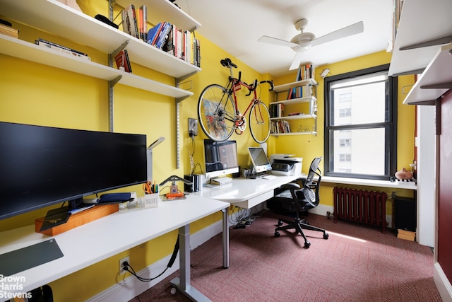 office area featuring carpet, radiator heating unit, and ceiling fan