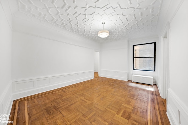 empty room with radiator and light parquet flooring