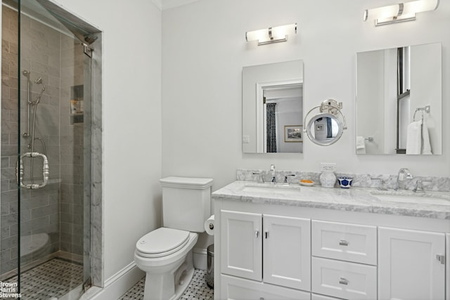 bathroom with vanity with extensive cabinet space, toilet, tile flooring, an enclosed shower, and double sink