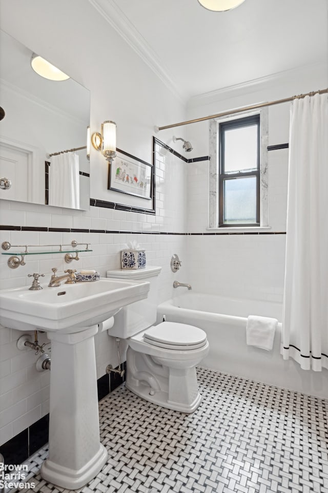 bathroom with tile flooring, tile walls, toilet, and shower / tub combo with curtain