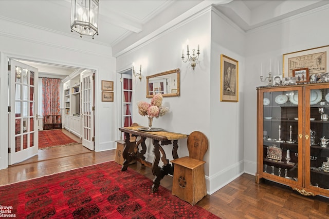 interior space with a chandelier, french doors, parquet floors, and ornamental molding