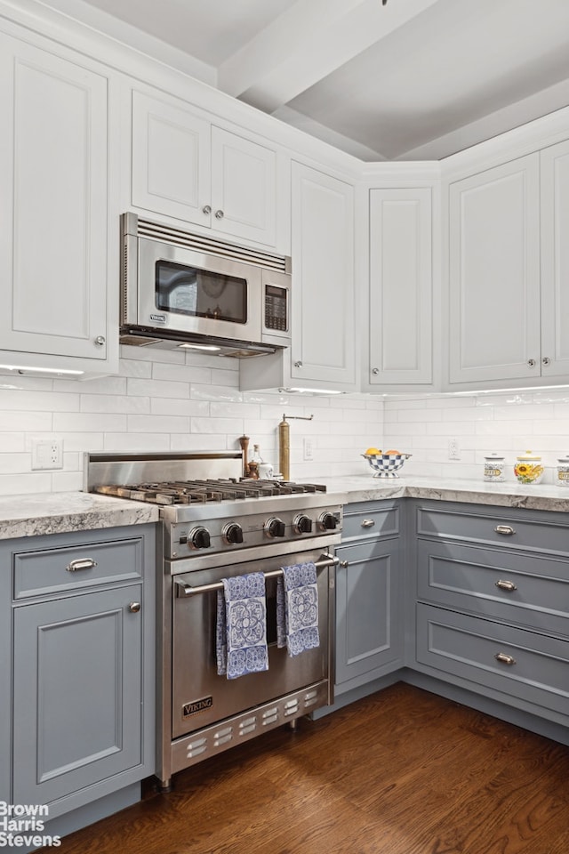 kitchen with dark hardwood / wood-style floors, light stone countertops, stainless steel appliances, and gray cabinets