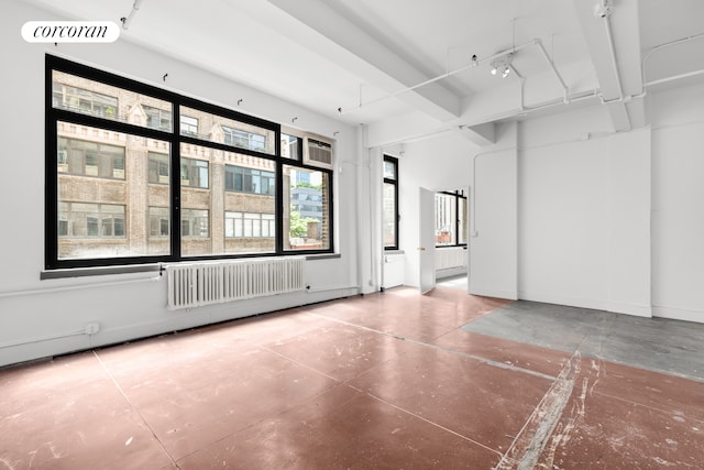 empty room with radiator and concrete floors