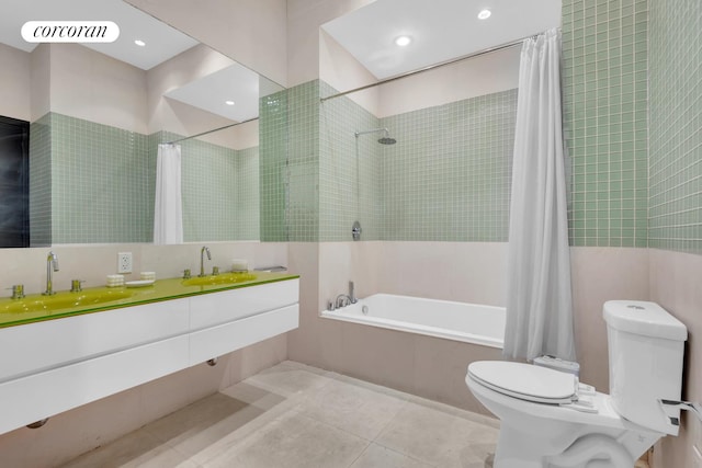 bathroom with tile patterned flooring, dual vanity, and toilet