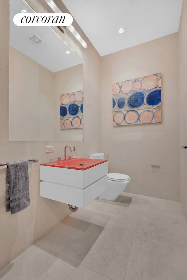 bathroom featuring tile patterned flooring and toilet