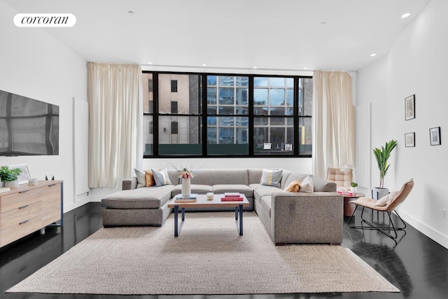 living room with hardwood / wood-style flooring and a wall of windows