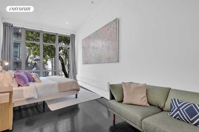 bedroom featuring floor to ceiling windows and hardwood / wood-style flooring