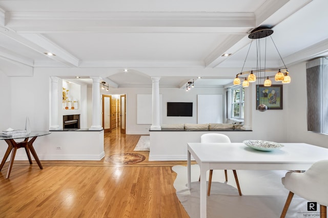 dining area featuring beam ceiling, decorative columns, light wood-type flooring, and ornamental molding