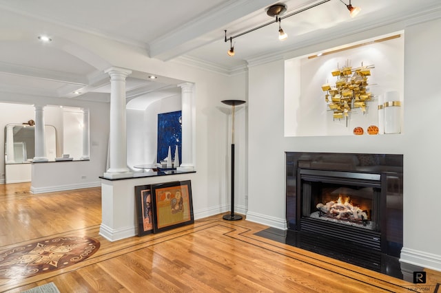 interior space featuring beamed ceiling, light hardwood / wood-style flooring, decorative columns, and crown molding