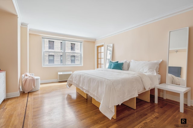 bedroom featuring wood-type flooring and crown molding