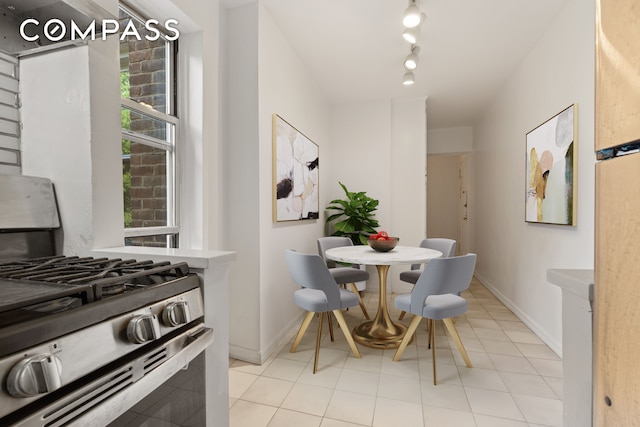 tiled dining space featuring rail lighting