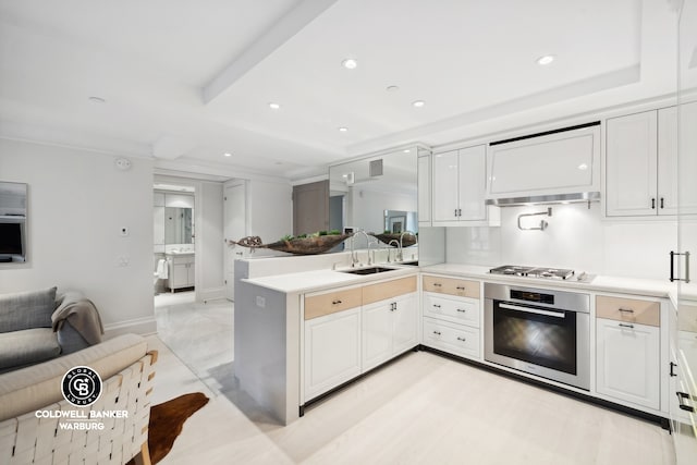 kitchen with appliances with stainless steel finishes, white cabinets, sink, kitchen peninsula, and light tile patterned floors