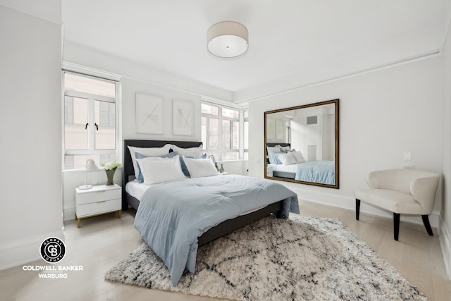 bedroom featuring multiple windows and hardwood / wood-style floors