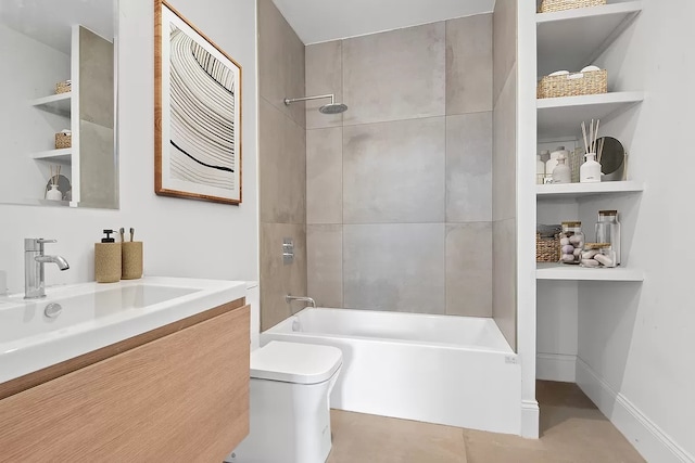 full bathroom featuring vanity, tiled shower / bath, and toilet