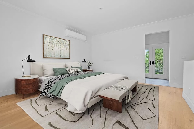 bedroom with french doors, light hardwood / wood-style floors, access to outside, an AC wall unit, and ornamental molding