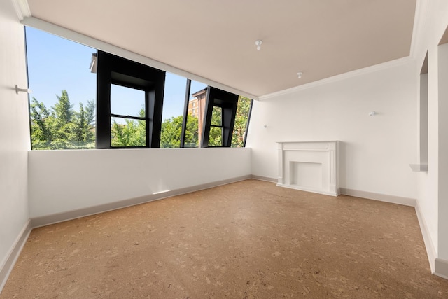 unfurnished living room with ornamental molding