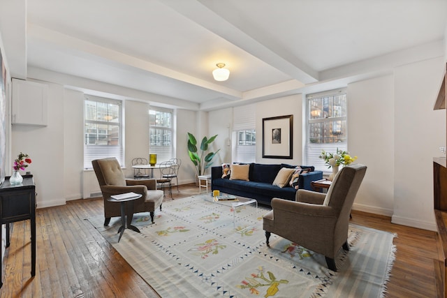 living room featuring beamed ceiling and hardwood / wood-style floors