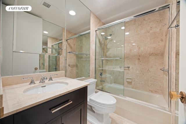 full bathroom with toilet, vanity, bath / shower combo with glass door, and tile patterned floors