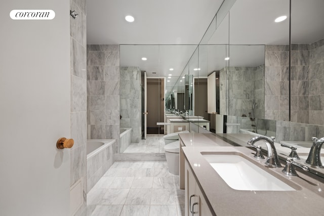 full bathroom featuring vanity, toilet, and tile walls