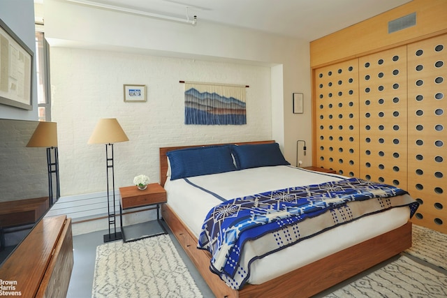 bedroom featuring concrete flooring