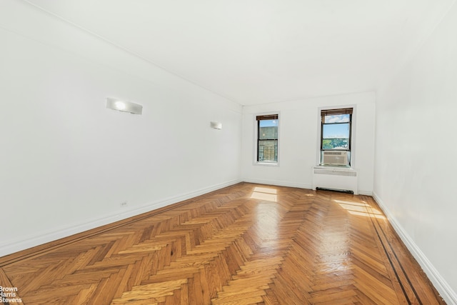 empty room featuring radiator heating unit and light parquet flooring