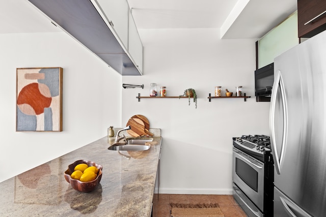 kitchen featuring white cabinetry, appliances with stainless steel finishes, sink, and light tile patterned floors