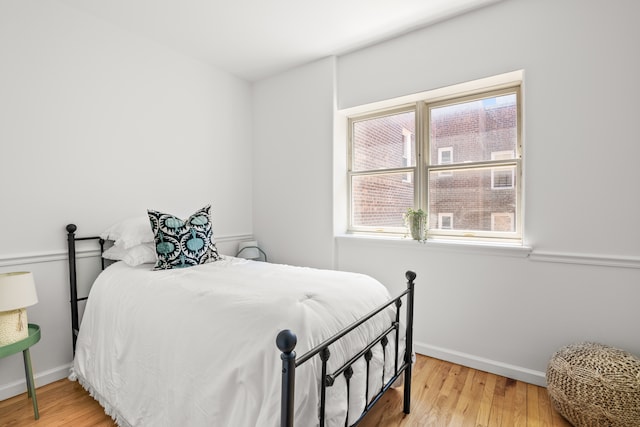 bedroom featuring hardwood / wood-style floors and multiple windows