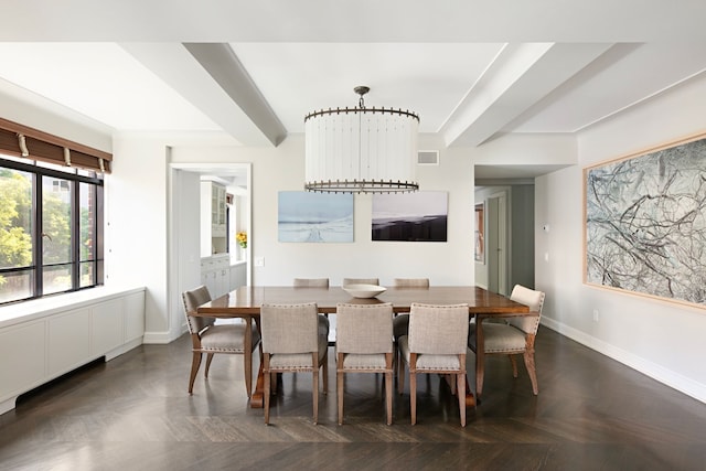 dining room with dark parquet flooring, a chandelier, and a tray ceiling