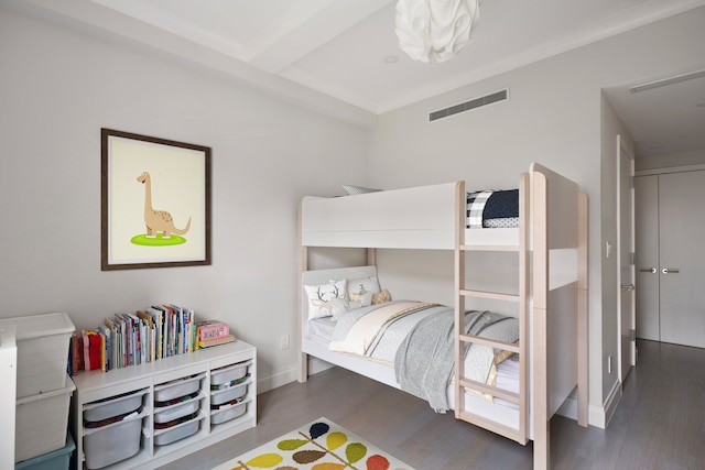 bedroom with dark hardwood / wood-style flooring