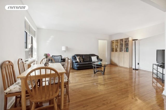 dining space with wood-type flooring