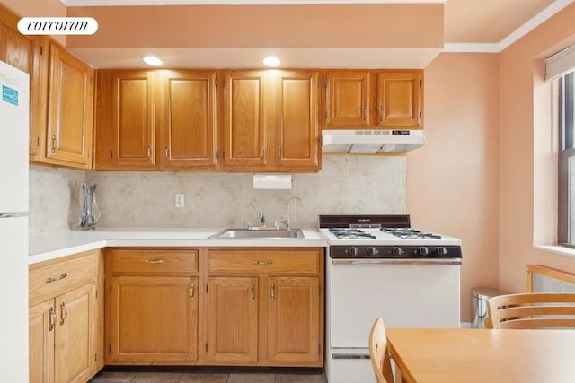 kitchen with tasteful backsplash, white appliances, crown molding, and sink