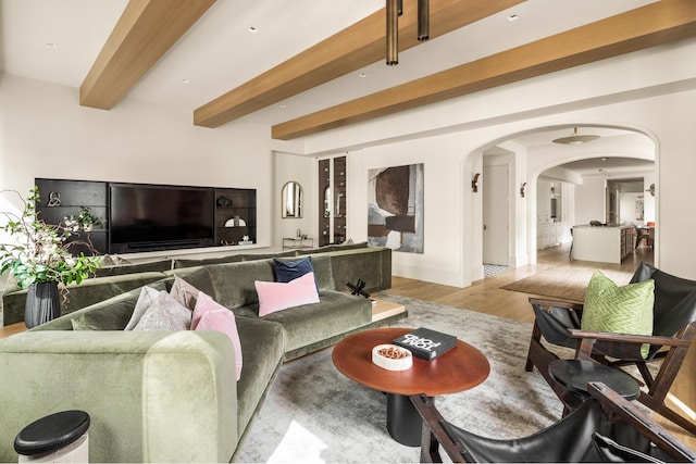 interior space with light hardwood / wood-style floors and beam ceiling