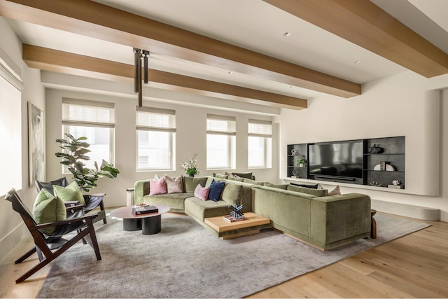 living room with light hardwood / wood-style floors and beamed ceiling