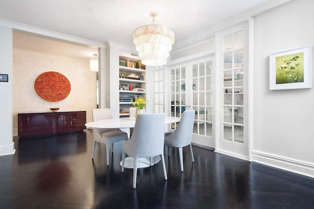 dining space featuring crown molding, french doors, hardwood / wood-style flooring, and a notable chandelier