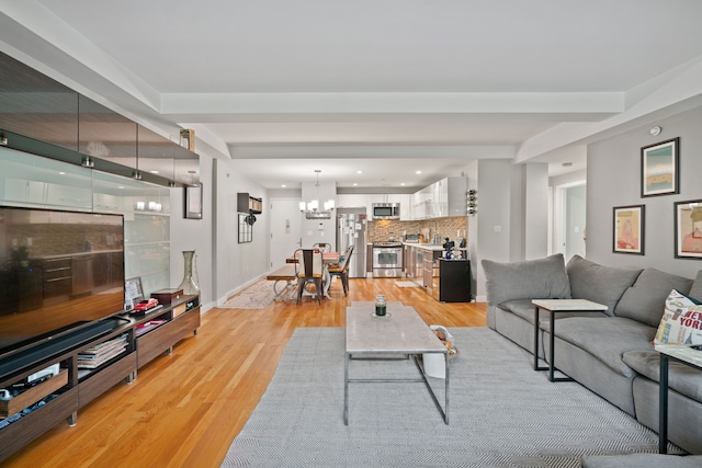 living room featuring light hardwood / wood-style floors and a chandelier