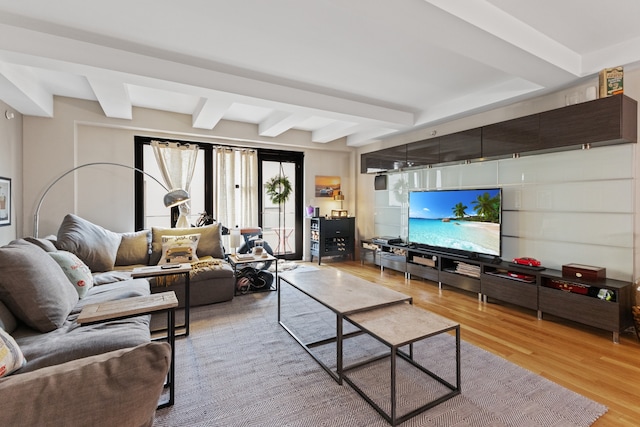 living room featuring light hardwood / wood-style floors and beam ceiling