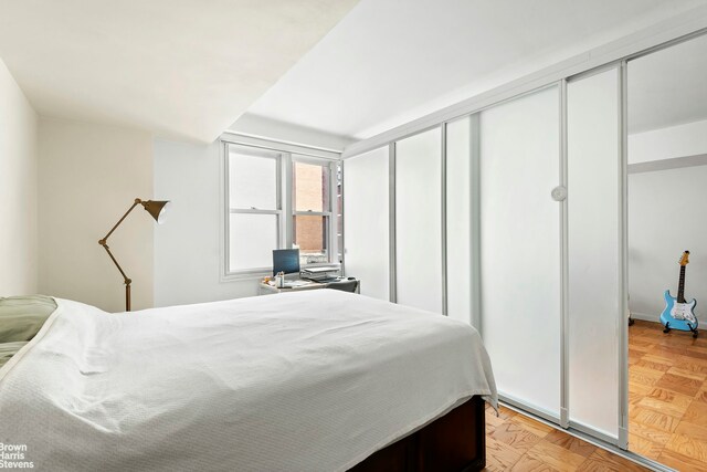 bedroom featuring light parquet floors