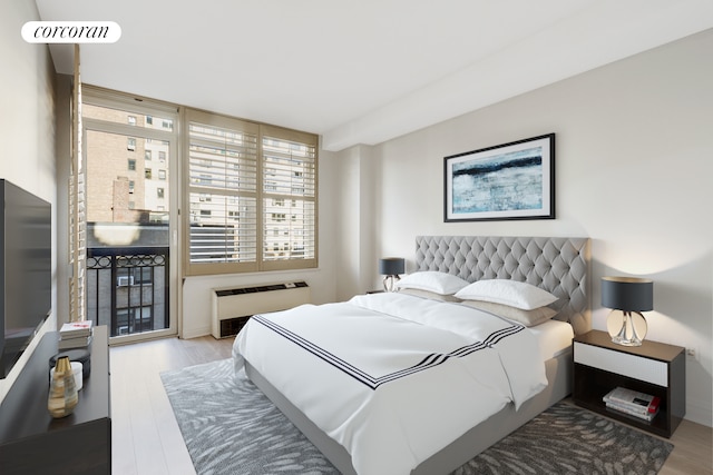 bedroom featuring wood-type flooring and radiator heating unit