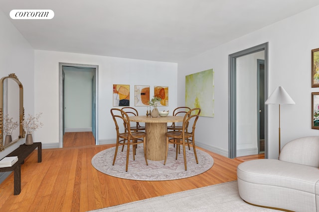 dining space with light hardwood / wood-style flooring