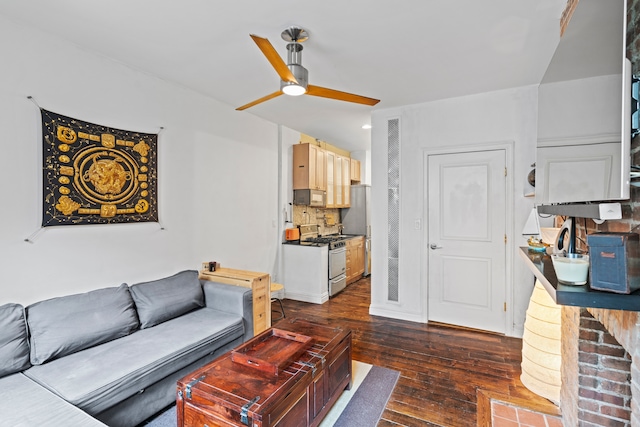 living room featuring dark hardwood / wood-style flooring and ceiling fan