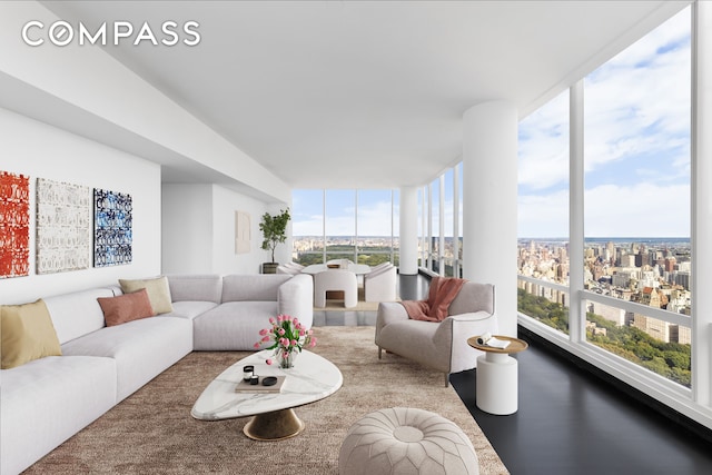 living room featuring floor to ceiling windows, hardwood / wood-style flooring, and plenty of natural light