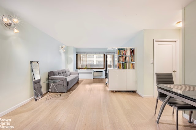 interior space featuring an AC wall unit and light hardwood / wood-style floors