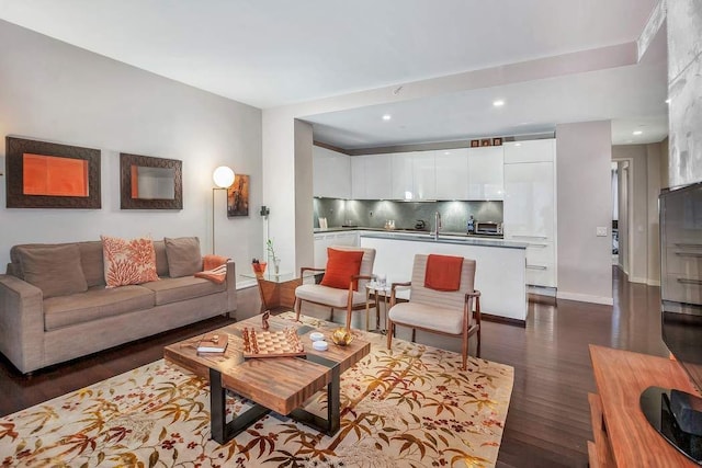 living room with sink and dark wood-type flooring