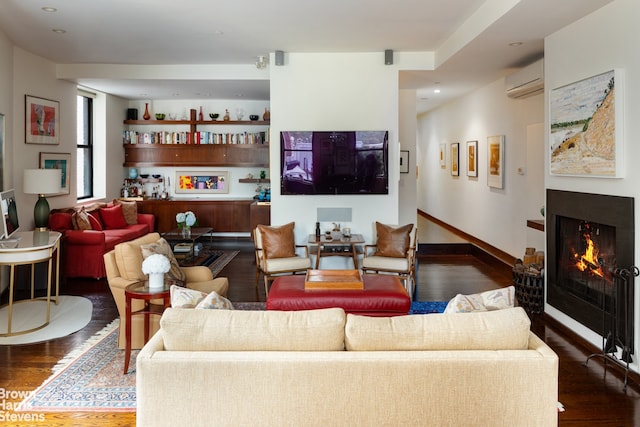 living room featuring a wall mounted AC and dark wood-type flooring