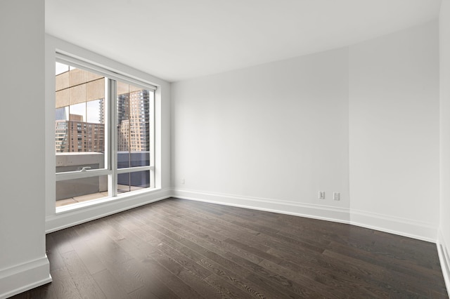 spare room with dark hardwood / wood-style flooring