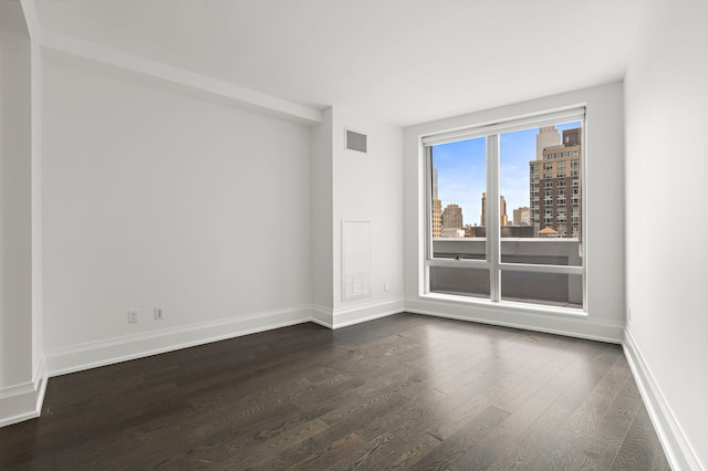 spare room with dark hardwood / wood-style floors