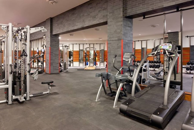 gym featuring ornate columns